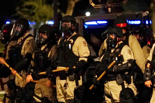 Police in riot gear surround the Arizona Capitol after protesters reached the front of the state Senate building in reaction to the Supreme Court decision to overturn the landmark Roe v. Wade abortion decision on Friday. (Photo: via Associated Press)