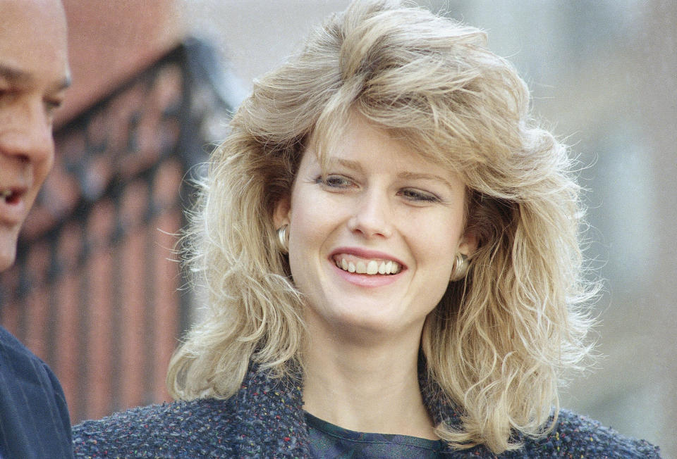 FILE - Fawn Hall, former secretary to ousted National Security Council Lt. Col. Oliver, speaks to reporters outside her lawyers’ office in Washington on Tuesday, Feb. 24, 1987. Hall testifed in the Iran-Contra trial of former White House national security adviser John Poindexter, said she removed documents from North’s office after he was fired even though she knew she wasn’t supposed to be doing so. (AP Photo/Ron Edmonds, File)