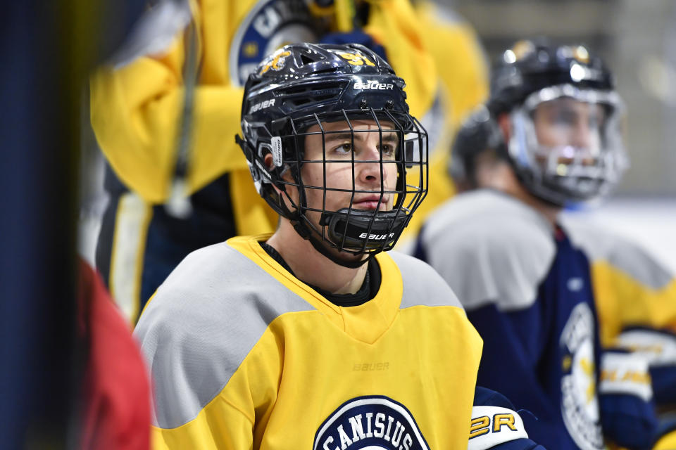 Canisius left wing Alton McDermott listens to coaches instructions during an NCAA college hockey practice in Buffalo, N.Y., Thursday, Jan. 26, 2023. McDermott's grandfather, former NHLer Paul Henderson, scored the decisive goal in clinching Canada its Summit Series win over Russia some 50 years ago and will celebrate his 80th birthday with a ceremonial puck drop before Cansius' game against Niagara. (AP Photo/Adrian Kraus)