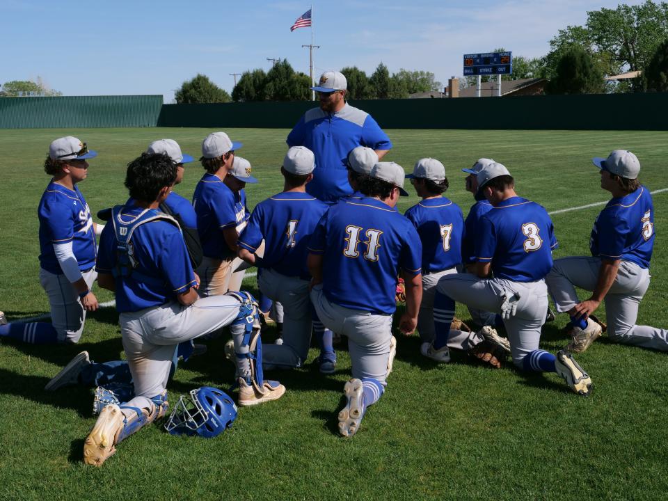 Sunray head coach Chuck Graves (standing) speaks with his team after their win over Gruver on Monday, May 1, 2023 at Sanford-Fritch High School.