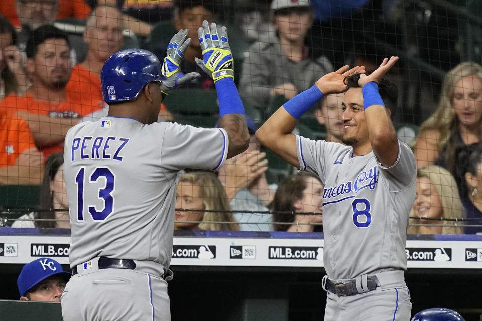 Kansas City Royals' Salvador Perez (13) celebrates with Nicky Lopez (8) after hitting a home run against the Houston Astros during the third inning of a baseball game Monday, Aug. 23, 2021, in Houston. (AP Photo/David J. Phillip)