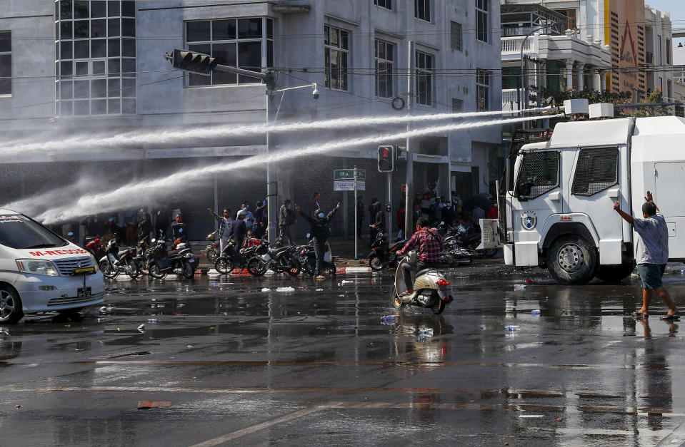 Police use water cannons to disperse demonstrators during a protest in Mandalay, Myanmar on Tuesday, Feb. 9, 2021. Protesters continued to gather Tuesday morning in major cities breaching Myanmar's new military rulers ban of public gathering of five or more issued on Monday intended to crack down on peaceful public protests opposing their takeover. (AP Photo)