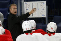 Calgary Flames associate coach Geoff Ward gives instruction during an NHL hockey practice Tuesday, Nov. 26, 2019, in Buffalo, N.Y. Flames general manager Brad Treliving says coach Bill Peters remains on the staff but wasn’t certain whether he’d be behind the bench for the next game. The team and the NHL are both investigating an allegation the Peters directed racial slurs at a player 10 years ago when the two were in the minors. Akim Aliu, a Nigerian-born player, says Peters “dropped the N bomb several times” in a dressing room during his rookie year. (AP Photo/Jeffrey T. Barnes)