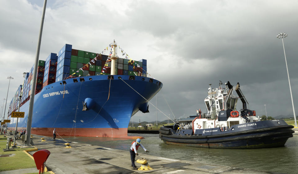 In this Dec. 3, 2018, photo, a Panama Canal worker docks the Chinese container ship Cosco at the Panama Canals' Cocoli Locks, in Panama City. China’s expansion in Latin America of its Belt and Road initiative to build ports and other trade-related facilities is stirring anxiety in Washington. As American officials express alarm at Beijing’s ambitions in a U.S.-dominated region, China has launched a charm offensive, wooing Panamanian politicians, professionals, and journalists. (AP Photo/Arnulfo Franco)