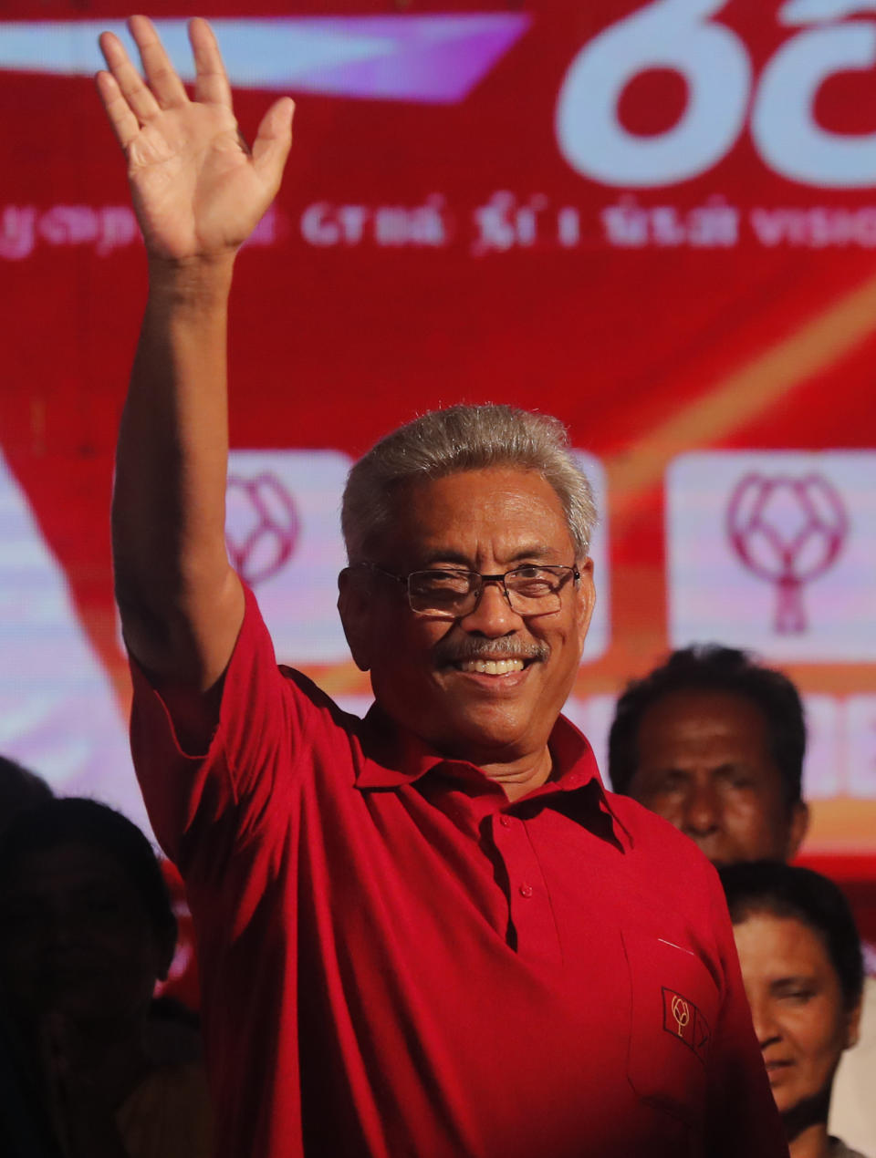 FILE- In this Wednesday, Nov. 13, 2019 file photo, Sri Lanka's former defense secretary and presidential candidate Gotabaya Rajapaksa waves to his supporters at a rally in Homagama, outskirts of Colombo, Sri Lanka. Sri Lanka’s ruling party presidential candidate conceded defeat on Sunday to Rajapaksa, marking the return of a family revered by the Sinhalese Buddhist majority for the victory over the Tamil Tiger rebels but feared by Tamil and Muslim minorities. (AP Photo/Eranga Jayawardena, File)