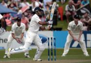 India's MS Dhoni plays a shot against New Zealand during the first innings on day two of the second international test cricket match at the Basin Reserve in Wellington, February 15, 2014.