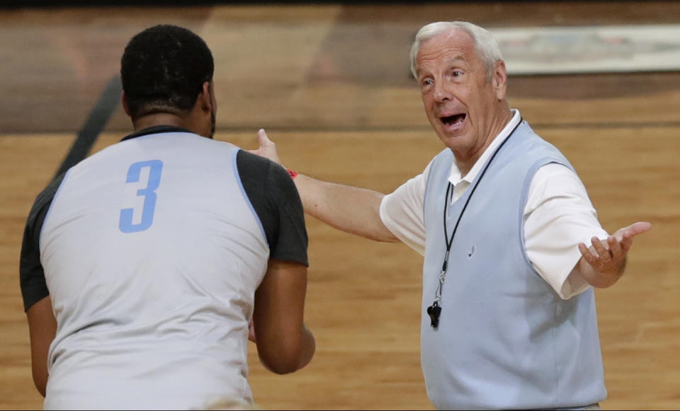 North Carolina head coach Roy Williams, right, talks with forward Kennedy Meeks during a practice session for their NCAA Final Four tournament college basketball semifinal game Friday, March 31, 2017, in Glendale, Ariz. (AP Photo/Matt York)