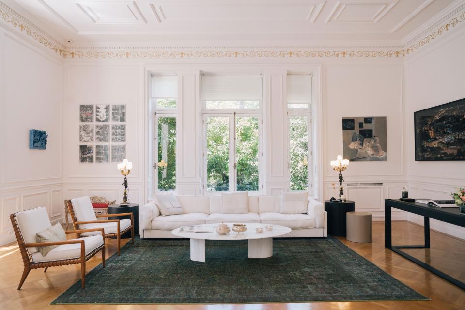 The “living room” of the Maximos Mansion, where dignitaries meeting with the prime minister are received, is filled with notable Greek art and furniture. The carpet is from Ten Carpets by Soutzoglou, the marble table from on.entropy, and the leather and walnut chairs are by Saridis of Athens. In the left corner of the room, Cityscape III, a work of blue enameled aluminum by Chryssa, is on loan from EMST, the National Museum of Contemporary Art. Perpendicular to that, nine framed works of newspaper collage by Bia Davou hang above an ornate forged iron couch by artist Maro Michalakakos. The opposite corner features an untitled canvas by Apostolos Georgiou and a photograph of Athens by Panos Kokkinias.