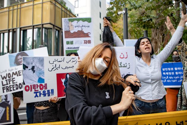 A member of the Iranian community cuts her hair during a rally outside the Iranian Embassy in Seoul, South Korea, on Wednesday. (Photo: Chris Jung/NurPhoto via Getty Images)