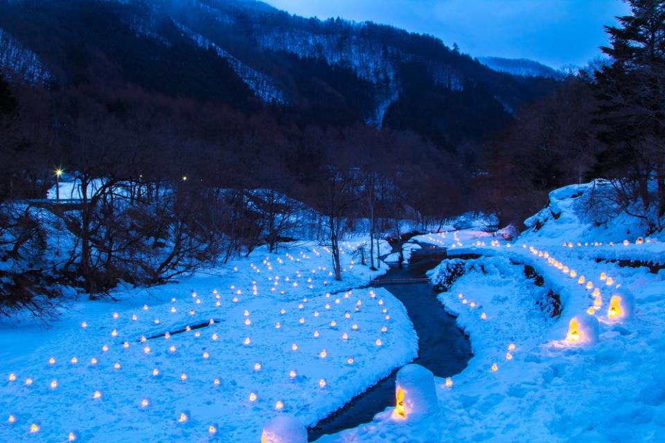 snow candles along a river in Japan