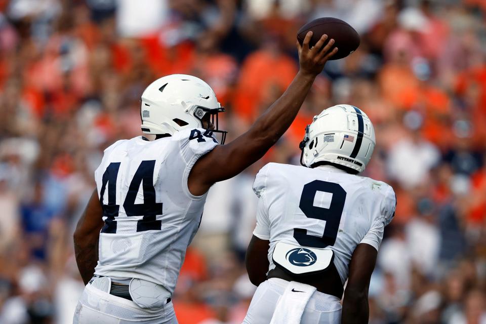 Penn State defensive end Chop Robinson (44) celebrates with Penn State cornerback Joey Porter Jr. (9) after recovering a fumble by Auburn quarterback T.J. Finley during the second half of an NCAA college football game Saturday, Sept. 17, 2022, in Auburn, Ala. (AP Photo/Butch Dill)