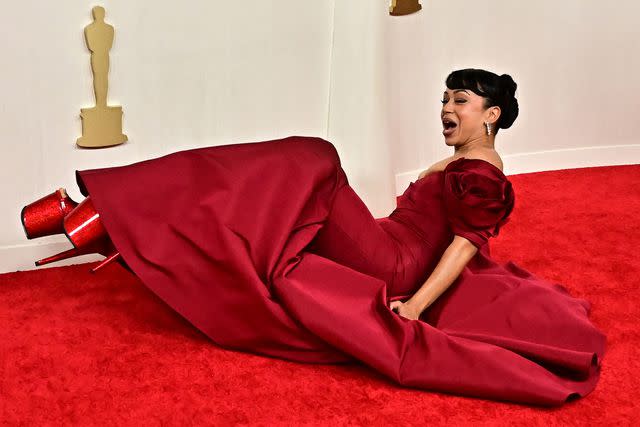 <p>FREDERIC J. BROWN/AFP via Getty</p> Liza Koshy tumbles in massive heels on 2024 Oscars red carpet