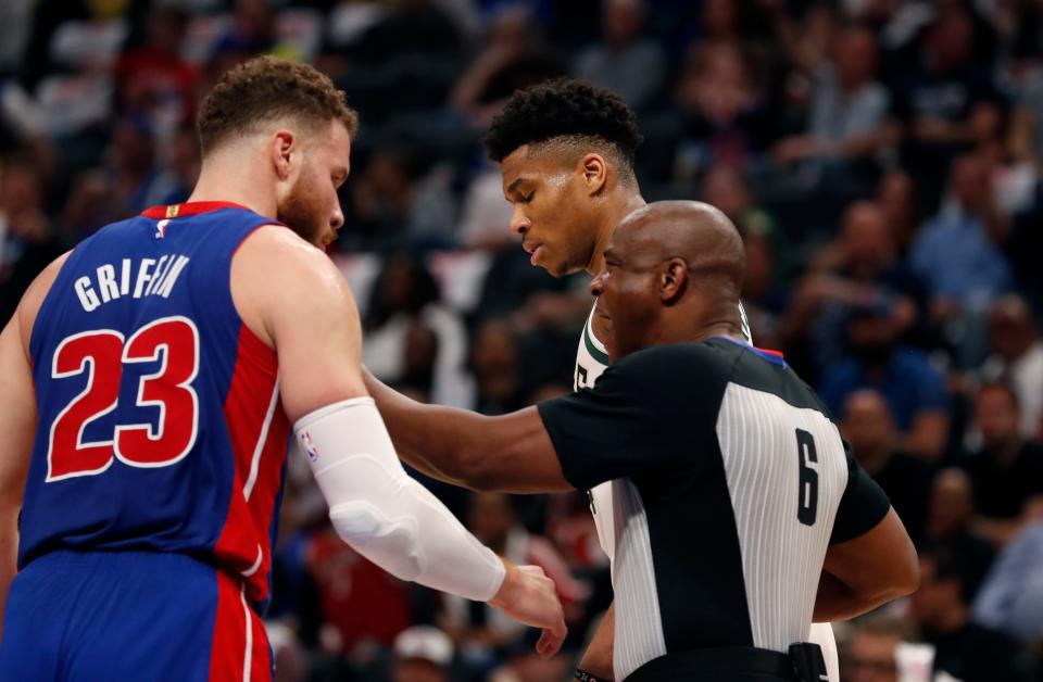 Referee Tony Brown (6) keeps Detroit Pistons forward Blake Griffin (23) and Milwaukee Bucks forward Giannis Antetokounmpo apart during the first half of Game 4 of a first-round NBA basketball playoff series, Monday, April 22, 2019, in Detroit. (AP Photo/Carlos Osorio)