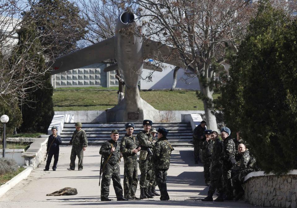 Ukrainian servicemen gather on the territory of their military unit located in the village of Lyubimovka near a local airfield, some 80 km (50 miles) southwest of Simferopol