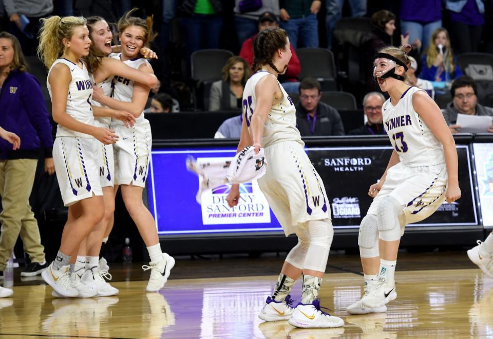 Winner players celebrate after winning a semifinal matchup against McCook Central/Montrose at the State A Girls Basketball Tournament in Sioux Falls on Friday.