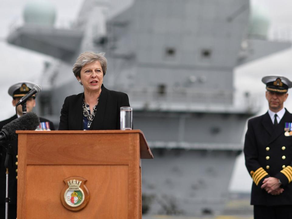 Theresa May stands on the flight deck as she speaks to crew members of the British aircraft carrier HMS Queen Elizabeth in Portsmouth on 16 August (Reuters)