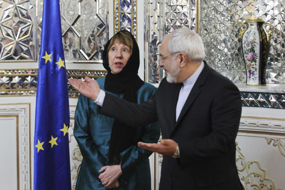 Iranian Foreign Minister Mohammad Javad Zarif, right, welcomes European Union's foreign policy chief Catherine Ashton for their meeting, in Tehran, Iran, Sunday, March 9, 2014. Ashton is saying there is no guarantee for a successful final nuclear deal with Iran. (AP Photo/Vahid Salemi)