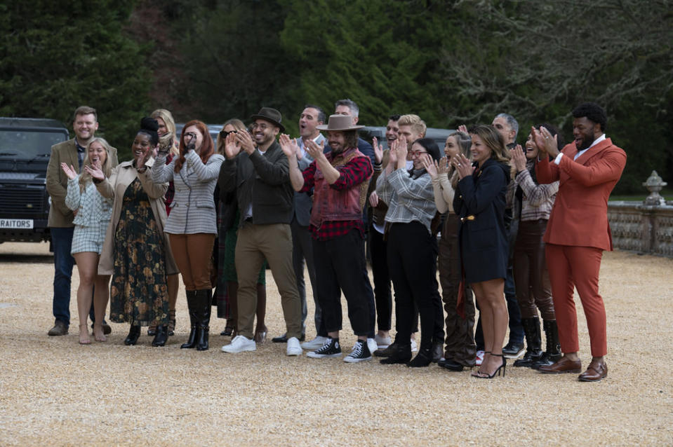 The cast claps outside the castle