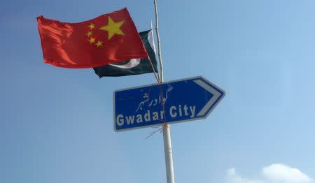 The Chinese and Pakistani flags fly on a sign along a road towards Gwadar, Pakistan January 26, 2016. Picture taken January 26, 2016. REUTERS/Syed Raza Hassan