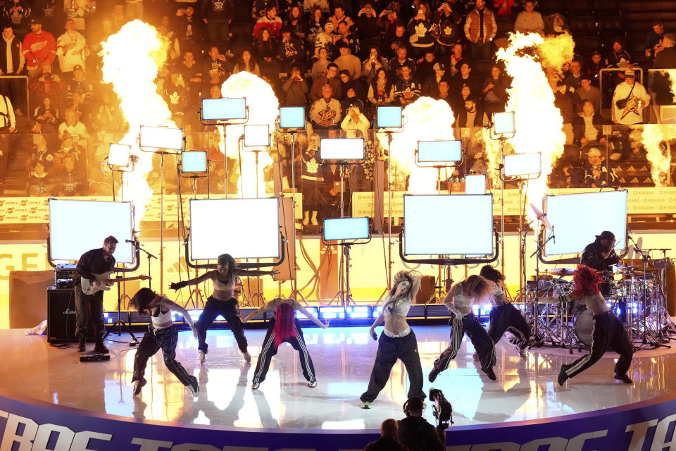 Singer Tate McRae, center right, performs during an intermission at hockey's NHL All-Star Game in Toronto, Saturday, Feb. 3, 2024. (Nathan Denette/The Canadian Press via AP)