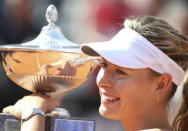 Maria Sharapova of Russia holds her trophy after winning the final match over Carla Suarez Navarro of Spain after their final match at the Rome Open tennis tournament in Rome, Italy, May 17, 2015. REUTERS/Stefano Rellandini