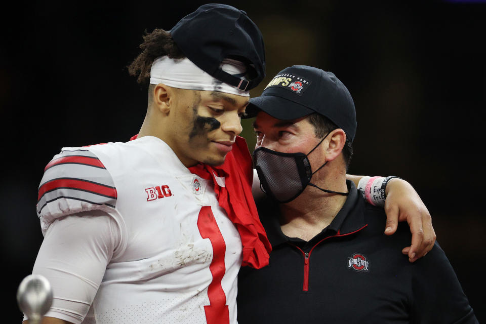 Justin Fields and head coach Ryan Day of the Ohio State Buckeyes react after defeating the Clemson Tigers, 49-28, on Jan 1. (Chris Graythen/Getty Images)