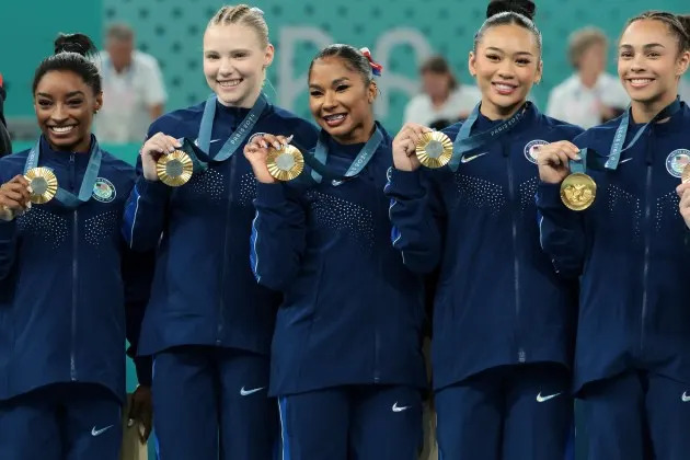 Gold medalists Simone Biles, Jade Carey, Jordan Chiles, Sunisa Lee, and Hezly Rivera (from left) of Team USA. - Credit: Jean Catuffe/Getty Images