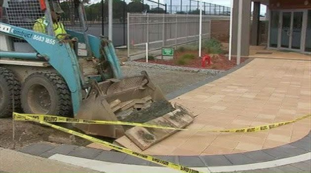 Joshua Ryan in his bobcat, trying to tear up the work he says he's owed money for.