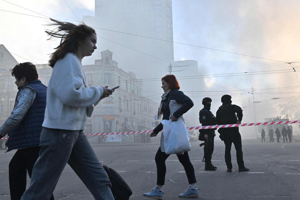 Local residents walk past police officers after a drone attack in Kyiv on Oct. 17 amid the Russian invasion of Ukraine.<span class="copyright">Sergei Supinsky—AFP/Getty Images</span>