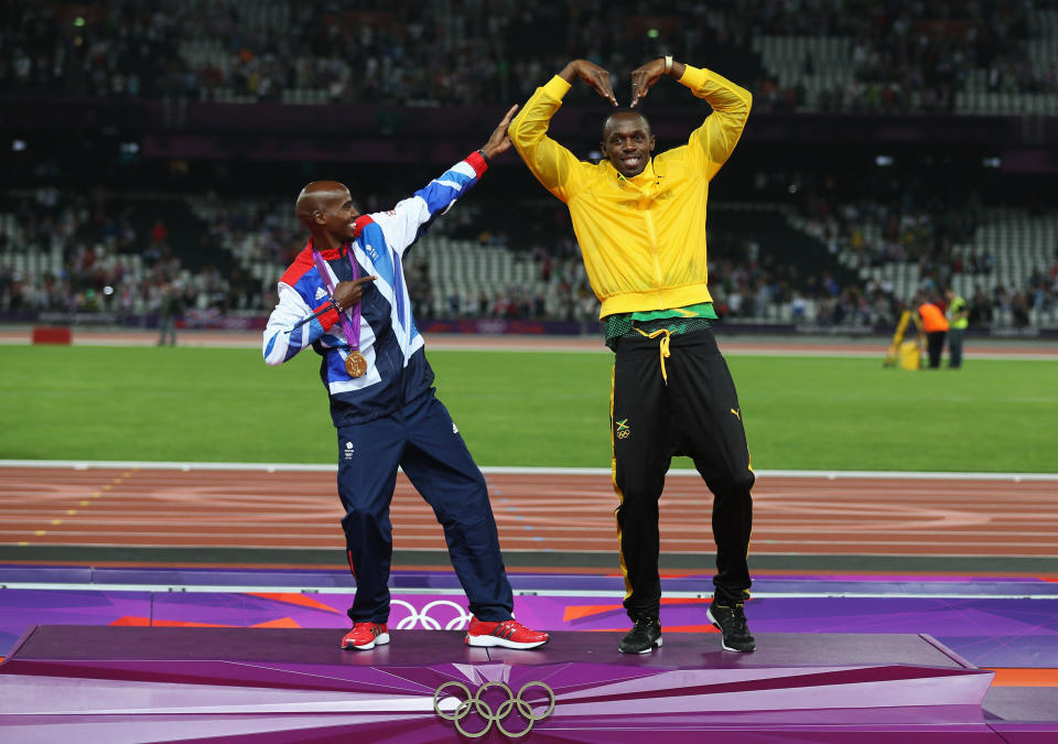 LONDON, ENGLAND - AUGUST 11: Gold medalist Mohamed Farah of Great Britain (L) and Usain Bolt of Jamaica pose on the podium on Day 15 of the London 2012 Olympic Games at Olympic Stadium on August 11, 2012 in London, England. (Photo by Clive Brunskill/Getty Images)