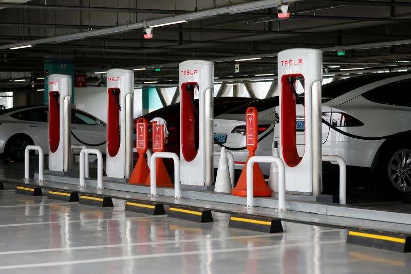 FILE PHOTO: Tesla electric vehicles are charged at a Tesla Supercharger charging station in Hanam