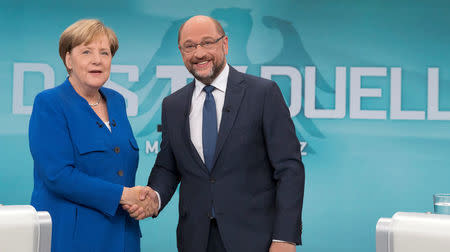 German Chancellor Angela Merkel of the Christian Democratic Union (CDU) and her challenger, Germany's Social Democratic Party SPD candidate for chancellor Martin Schulz, take part in a TV debate in Berlin, Germany, September 3, 2017. Herby Sachs/WDR/Handout via REUTERS