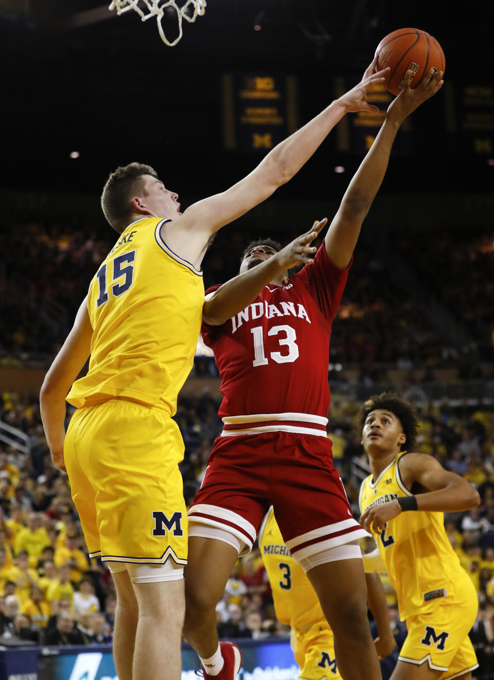 Michigan center Jon Teske (15) blocks a Indiana forward Juwan Morgan (13) shot in the first half of an NCAA college basketball game in Ann Arbor, Mich., Sunday, Jan. 6, 2019. (AP Photo/Paul Sancya)