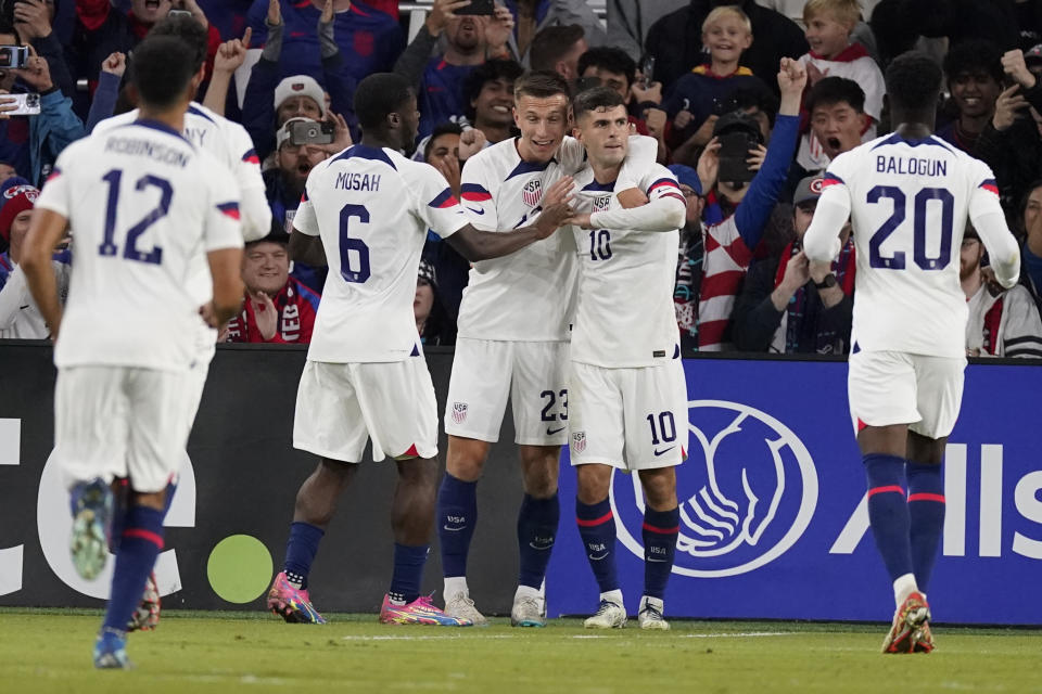 United States teammates congratulate forward Christian Pulisic (10) after a goal against Ghana during the first half of an international friendly soccer match Tuesday, Oct. 17, 2023, in Nashville, Tenn. (AP Photo/George Walker IV)