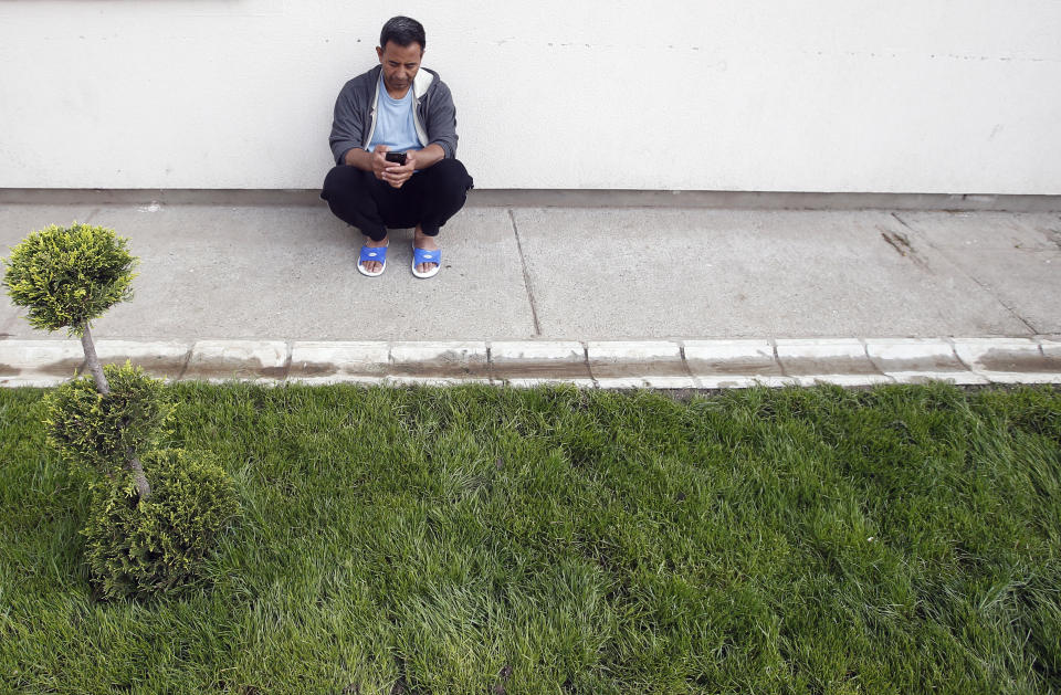 One of the Afghan asylum-seekers who was deported to Serbia in the middle of the night, checks his phone in center for asylum-seekers in the northern Serbian city of Subotica, Wednesday, May 8, 2019. Hungary, which greatly tightened asylum procedures last year, rejected the families' asylum requests and gave them the choice of being expelled to Serbia or being flown back to Afghanistan. (AP Photo/Darko Vojinovic)