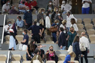 Spectators leave to respect the 11PM curfew due to the COVID-19 pandemic while Italy's Matteo Berrettini plays Serbia's Novak Djokovic in a quarterfinal match of the French Open tennis tournament at the Roland Garros stadium Wednesday, June 9, 2021 in Paris. (AP Photo/Michel Euler)
