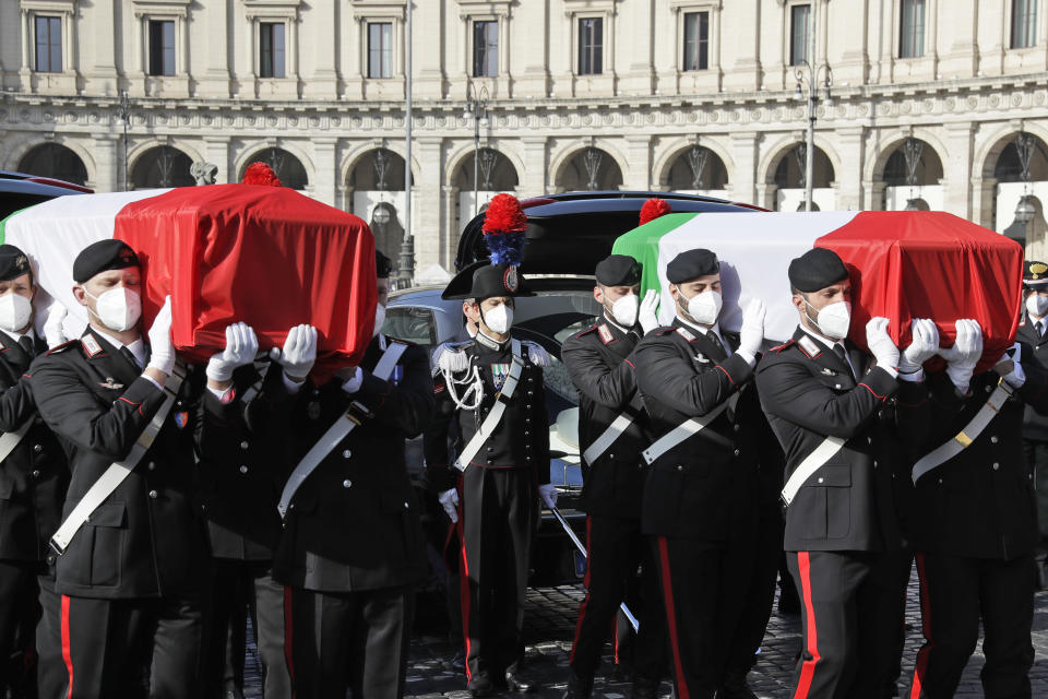 The coffins of the Italian ambassador to the Democratic Republic of Congo Luca Attanasio, right, and Italian Carabinieri police officer Vittorio Iacovacci are draped with the Italian flag ahead of their state funeral in Santa Maria degli Angeli church, in Rome, Thursday, Feb. 25, 2021. Italy is pressing the United Nations for answers about the attack Monday on a U.N. food aid convoy in Congo that left the young ambassador and his paramilitary police bodyguard dead. (AP Photo/Andrew Medichini)