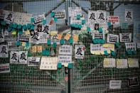 Posters and notes are pictured on a gate of Radio Television Hong Kong Broadcasting House headquarters during a protest outside in Hong Kong