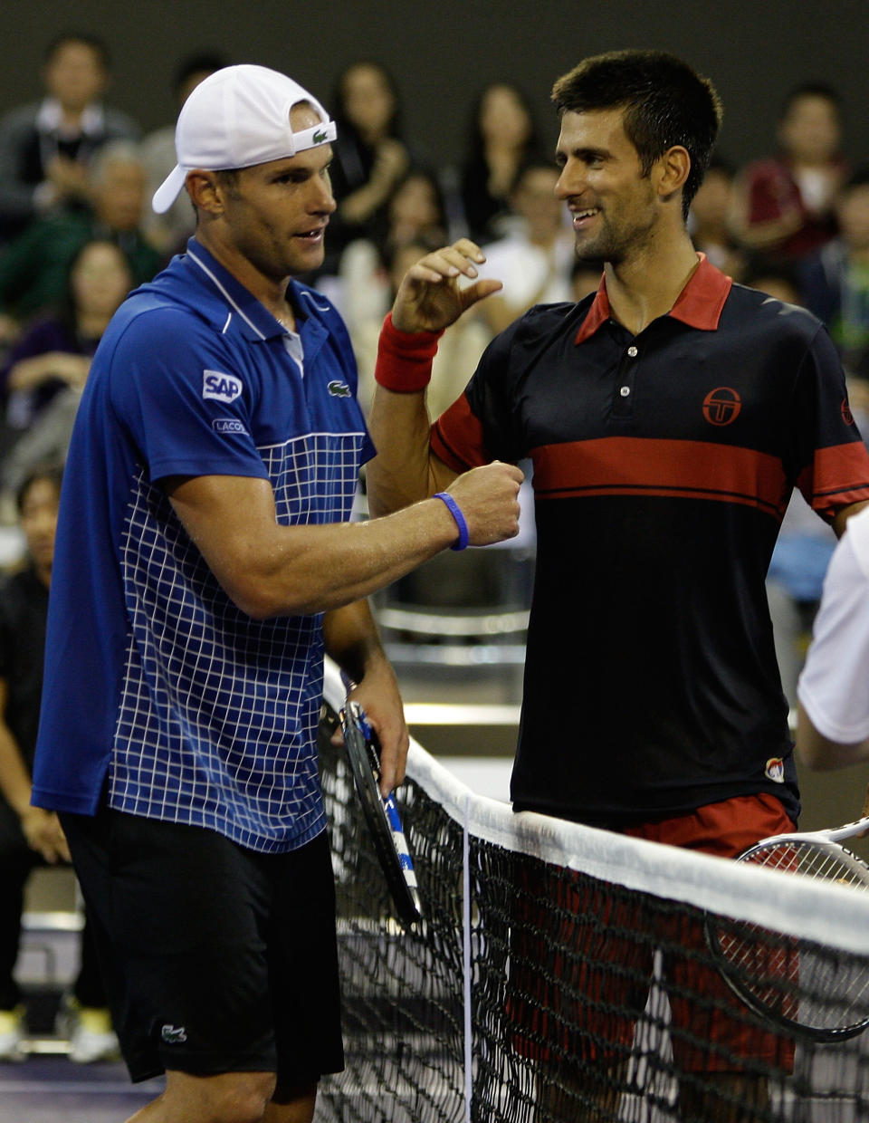 Andy Roddick (pictured left) shakes the hand of Novak Djokovic (pictured right) at the net.