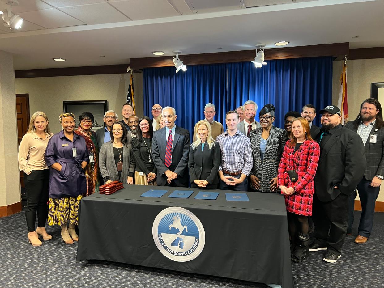 Mayor Donna Deegan (center) stands with members of her administration on Wednesday, Dec. 13, 2023, after the official signing of her transition committee recommendations passed by City Council the night prior.