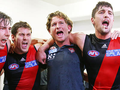 Coach James Hird and his players celebrate after one of the most difficult weeks in the club's history.