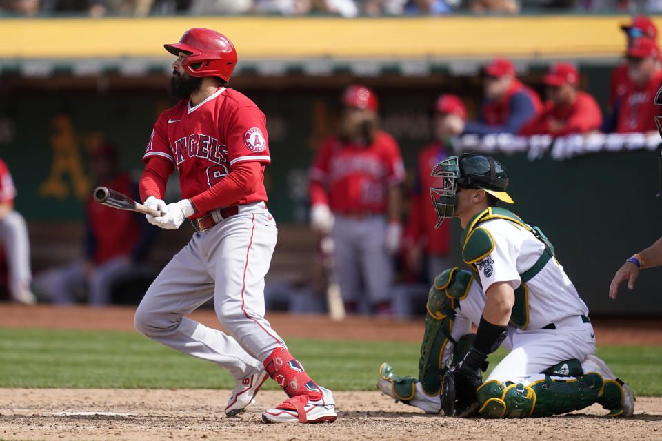 Los Angeles Angels' Anthony Rendon, left, watches his RBI-single in front of Oakland Athletics catcher Sean Murphy during the eighth inning of a baseball game in Oakland, Calif., Sunday, May 15, 2022. (AP Photo/Jeff Chiu)