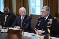 President Joe Biden listens during a meeting with Secretary of Defense Lloyd Austin, left, and Chairman of the Joint Chiefs of Staff Gen. Mark Milley, and other military leaders in the Cabinet Room the White House, Wednesday, April 20, 2022, in Washington. (AP Photo/Evan Vucci)