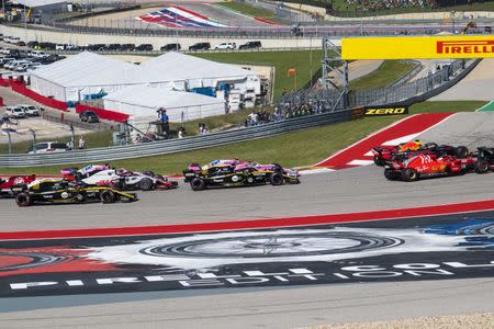 Oct 21, 2018; Austin, TX, USA; Ferrari driver Sebastian Vettel (5) of Germany and driver Daniel Ricciardo (3) driver Nico Hulkenberg (27) driver Esteban Ocon (31) driver Carlos Sainz (55) and driver Romain Grosjean (8) drive through turn one at the start of the United States Grand Prix at Circuit of the Americas. Mandatory Credit: Jerome Miron-USA TODAY Sports