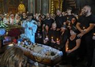 Relatives react during a funeral ceremony for 4 years old Liza Dmitrieva, who was killed during a recent Russian missile strike in Vinnytsia