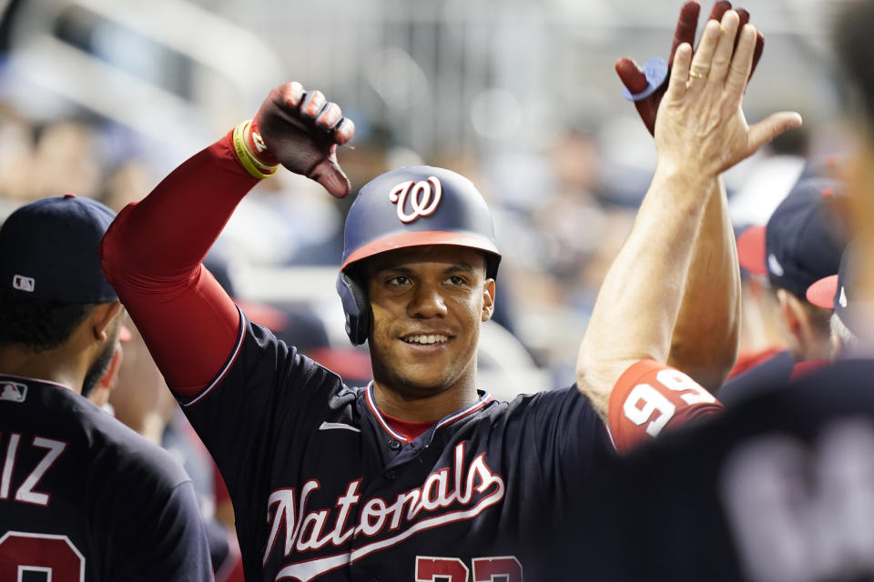 Washington Nationals' Juan Soto is cheered by the team after hitting a two-run home run in the third inning of a baseball game against the Miami Marlins, Wednesday, Sept. 22, 2021, in Miami. (AP Photo/Marta Lavandier)
