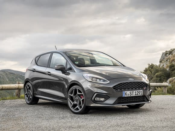 A European-spec 2018 Ford Fiesta ST hatchback in dark gray, parked on a mountain road