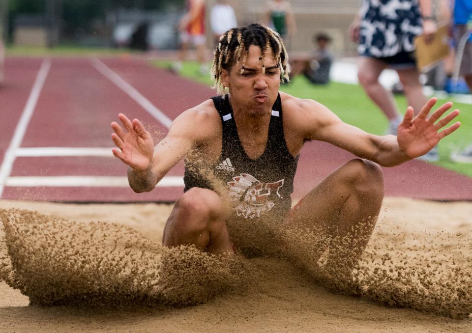 Harrison’s Jahni Summers lands in the pit during the long jump event of the IHSAA Boys Track and Field sectional 32 at Central High School in Evansville, Ind., Thursday, May 19, 2022. Summers jumped 22" 10.5 inches.