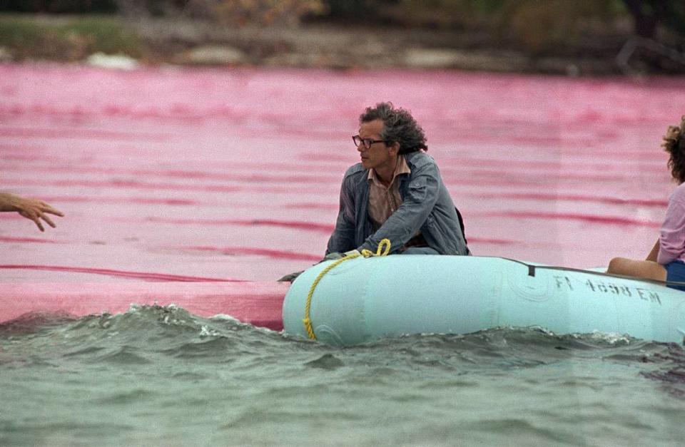 Artist Christo rides in an inflatable motorboat as he guides the installation of his ‘Surrounded Islands’ project in Biscayne Bay in May 1983.