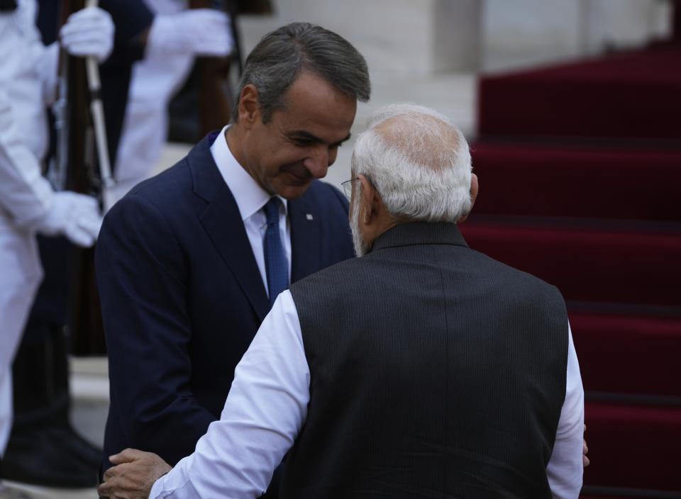 Greece's Prime Minister Kyriakos Mitsotakis, left, welcomes his Indian counterpart Narendra Modi at Maximos Mansion in Athens, Greece, Friday, Aug. 25, 2023. Modi's visit to Athens is especially significant for Greek foreign policy as it is the first official visit by an Indian prime minister to Greece in 40 years. (AP Photo/Thanassis Stavrakis)